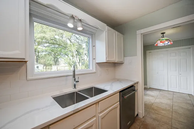 a kitchen with a sink cabinets and window