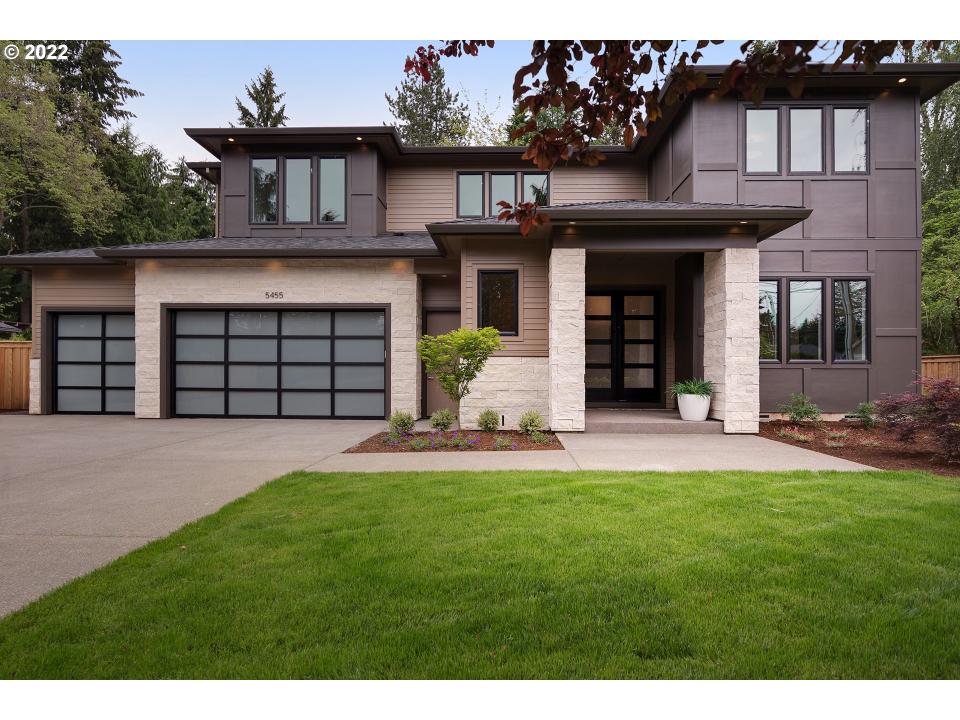 a front view of a house with a yard and garage