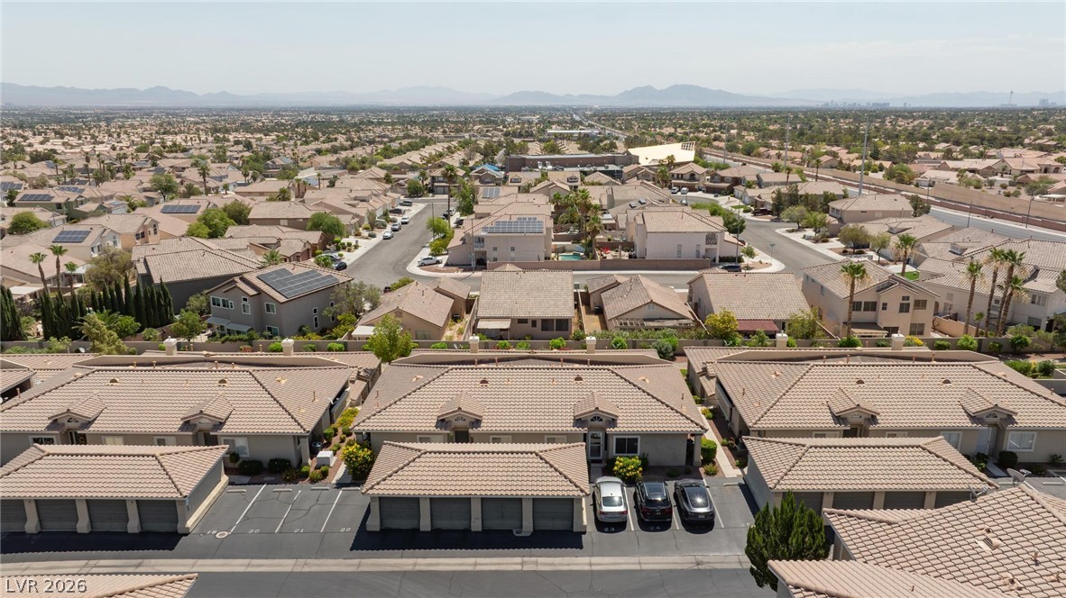 3238 Mystic Ridge Court Las Vegas, NV 89129 - Photo 29 of 31 An aerial panorama reveals a vast residential community with mountains framing the horizon.