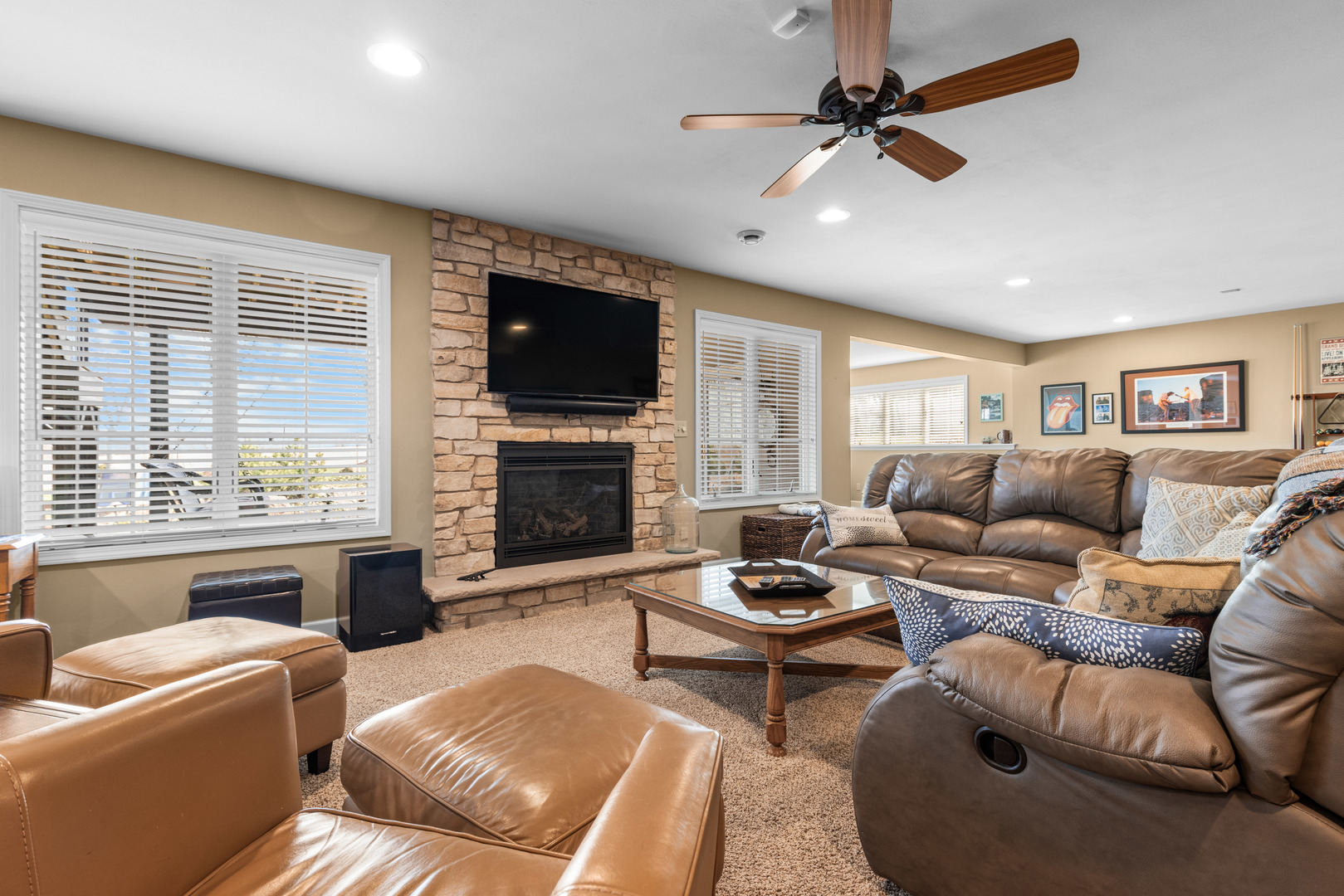 10125 Creek Ridge Trail Belvidere, IL 61008 - Photo 25 of 41 a living room with furniture a fireplace and a flat screen tv