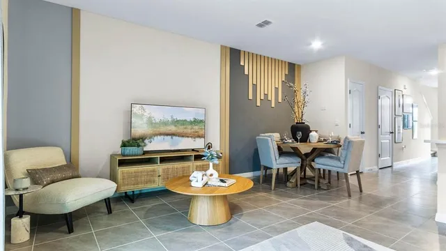 a living room with furniture a rug and a table