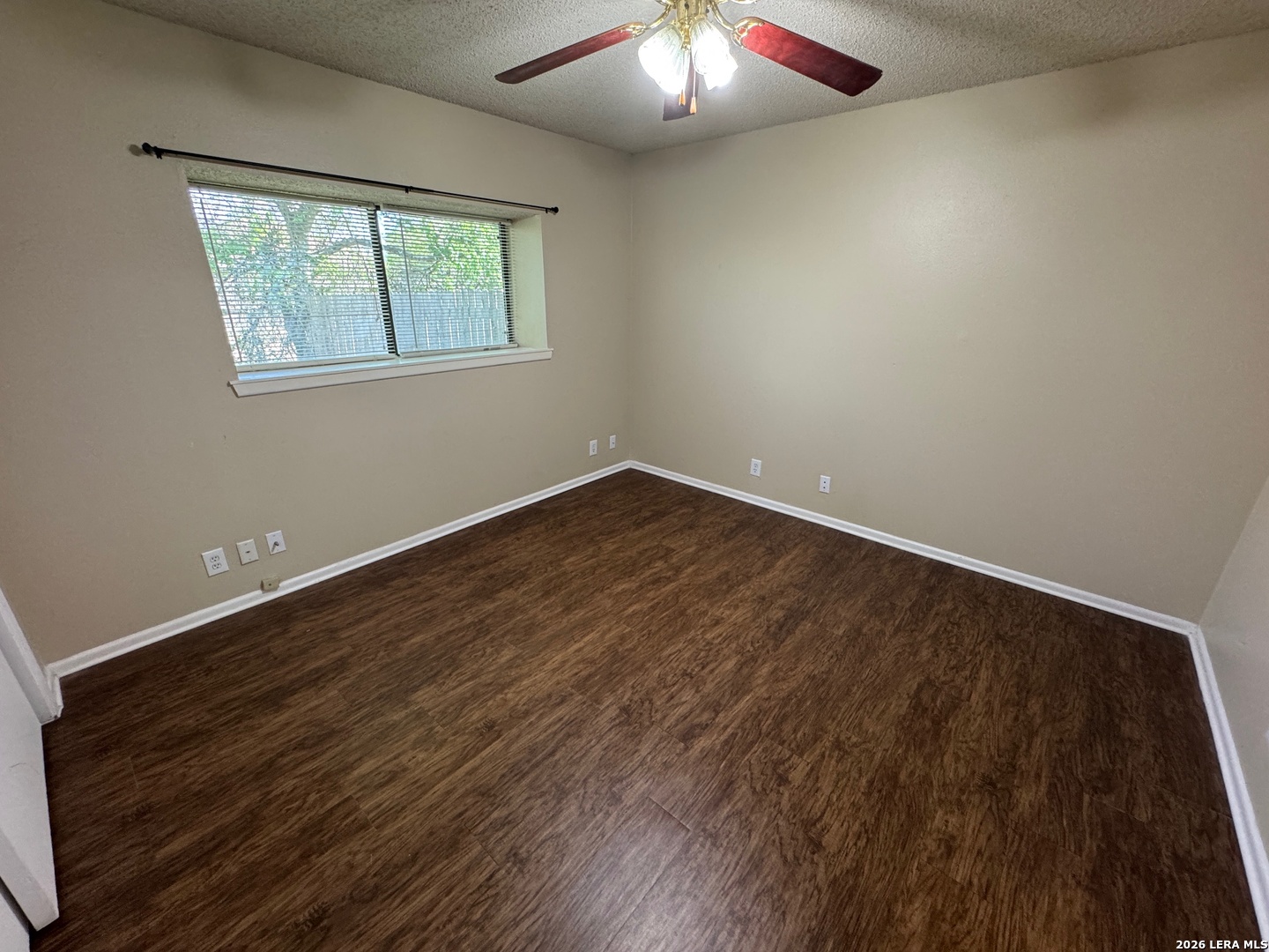 7236 Rimwood Street San Antonio, TX 78233 - Photo 11 of 16 an empty room with wooden floor and windows