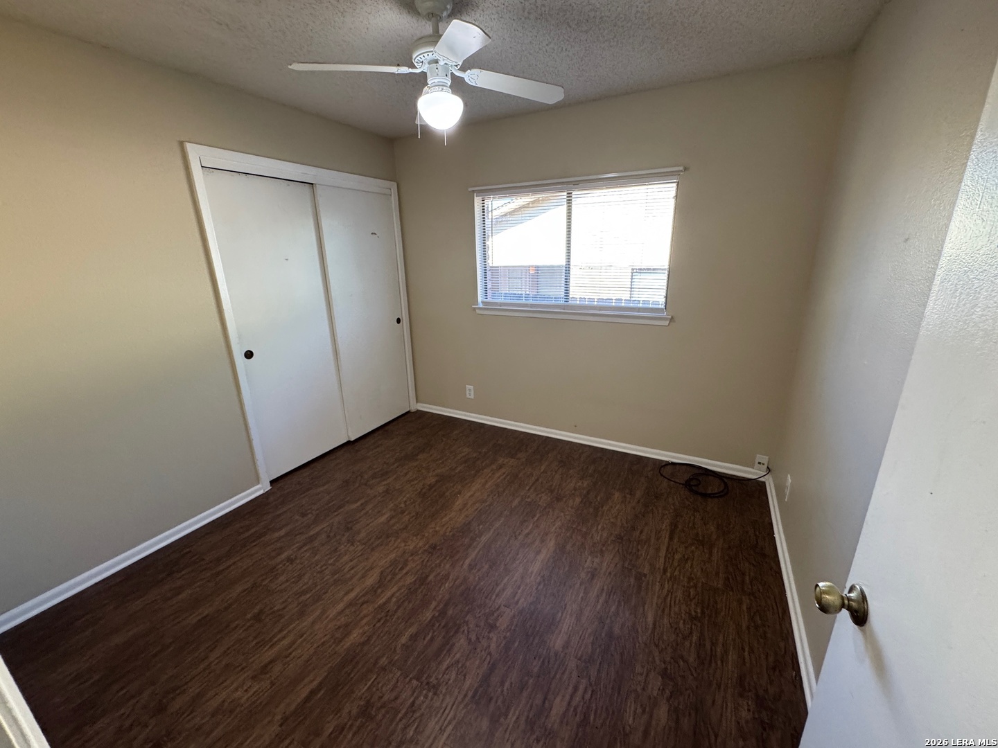 7236 Rimwood Street San Antonio, TX 78233 - Photo 14 of 16 a view of an empty room with wooden floor and a window
