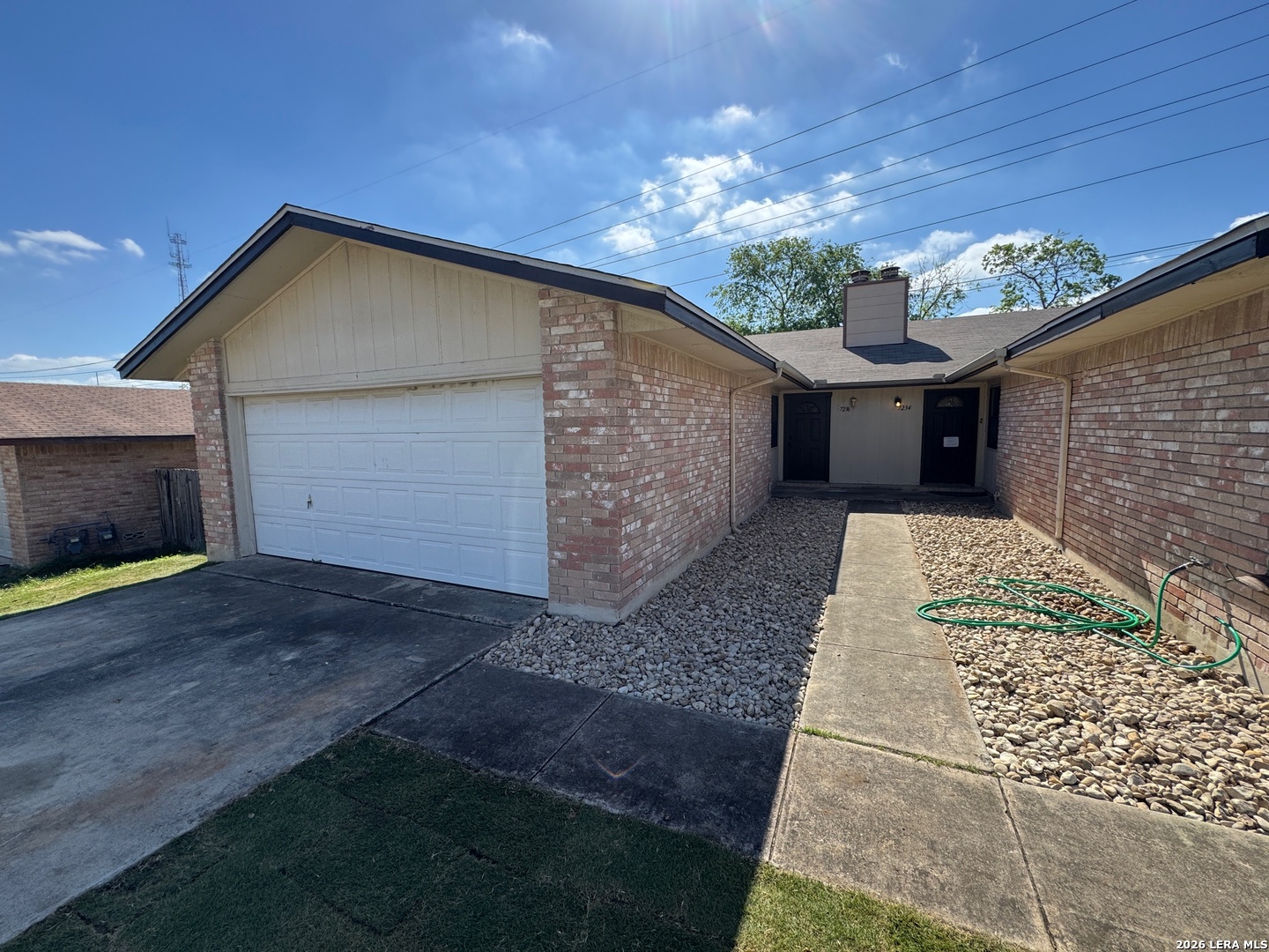 7236 Rimwood Street San Antonio, TX 78233 - Photo 3 of 16 a view of a house with a yard and garage