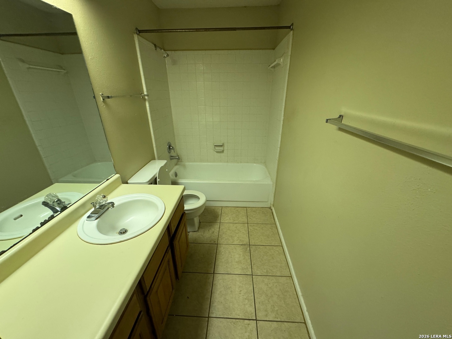 7236 Rimwood Street San Antonio, TX 78233 - Photo 10 of 16 a bathroom with a granite countertop sink a toilet and bathtub