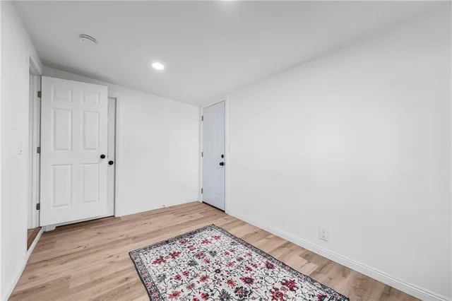 a bathroom with a toilet sink double vanity and mirror