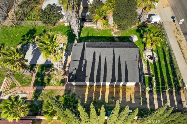 an aerial view of residential houses with outdoor space and street view