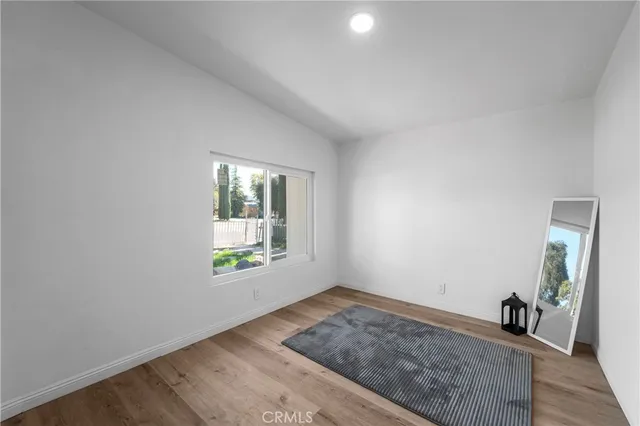 a view of a room with wooden floor