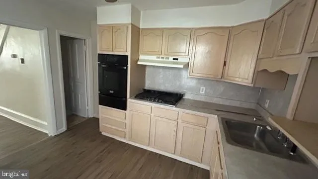 a kitchen with a sink and refrigerator
