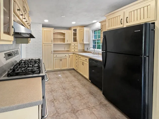 a kitchen with a refrigerator and a sink
