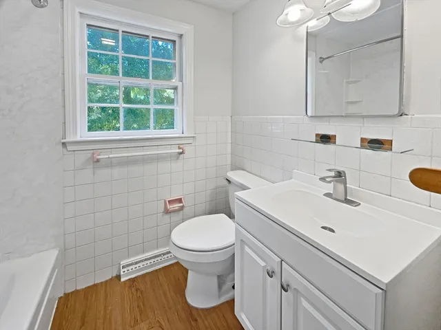 a bathroom with a sink a toilet and a mirror