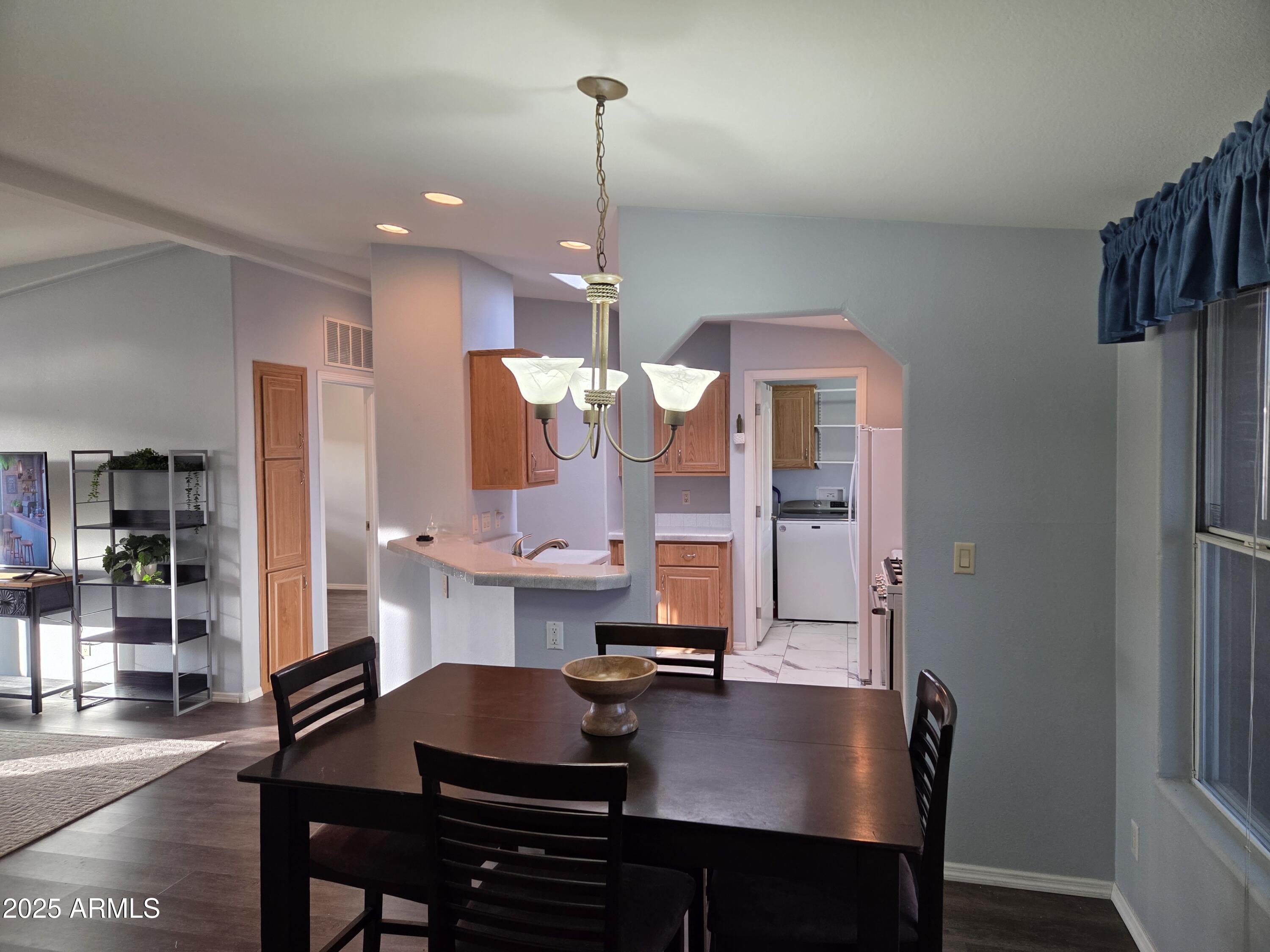 2929 East Main Street, Unit 107 Mesa, AZ 85213 - Photo 11 of 42 a kitchen with a table chairs and cabinets