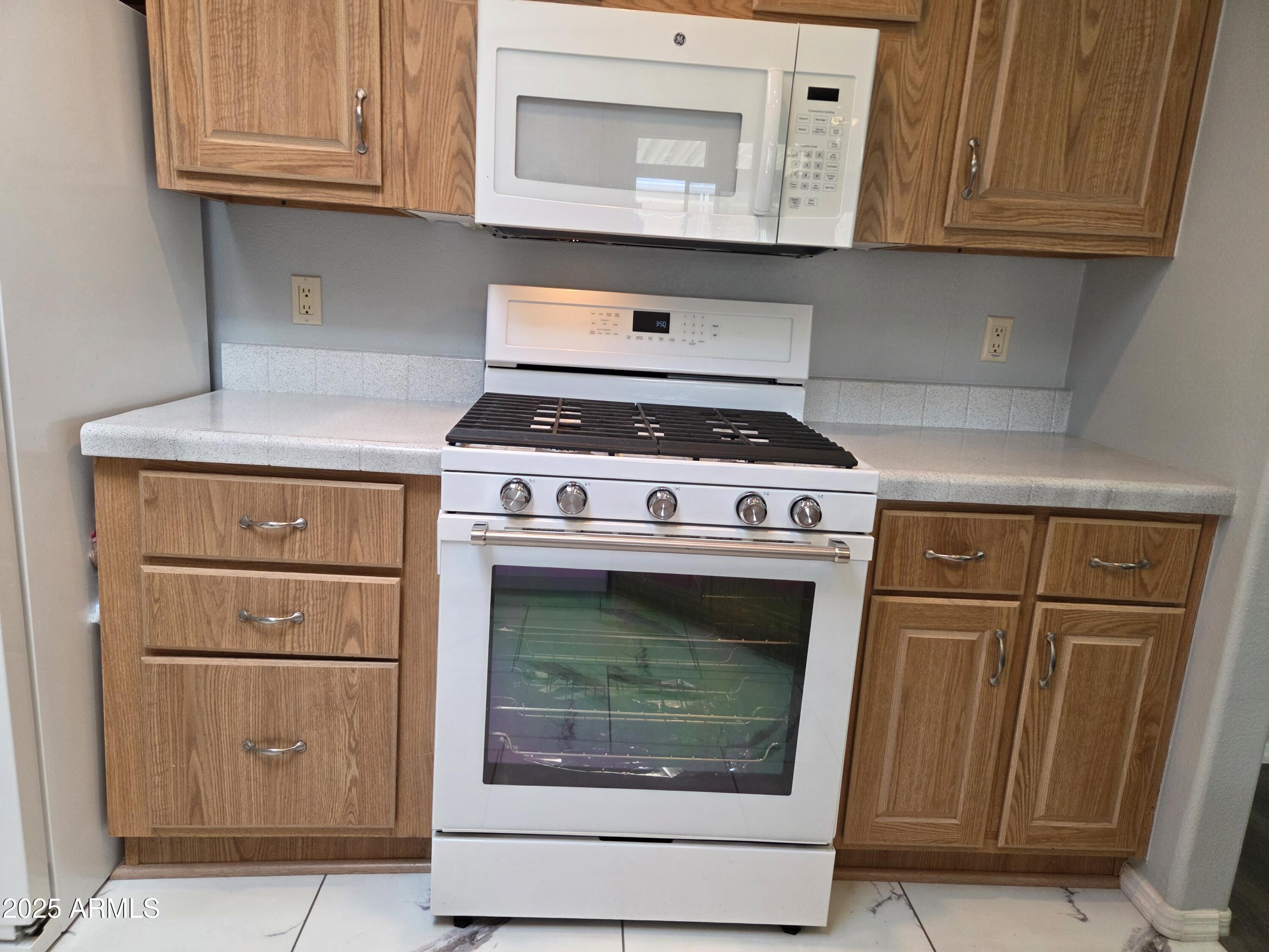 2929 East Main Street, Unit 107 Mesa, AZ 85213 - Photo 15 of 42 a stove top oven sitting inside of a kitchen