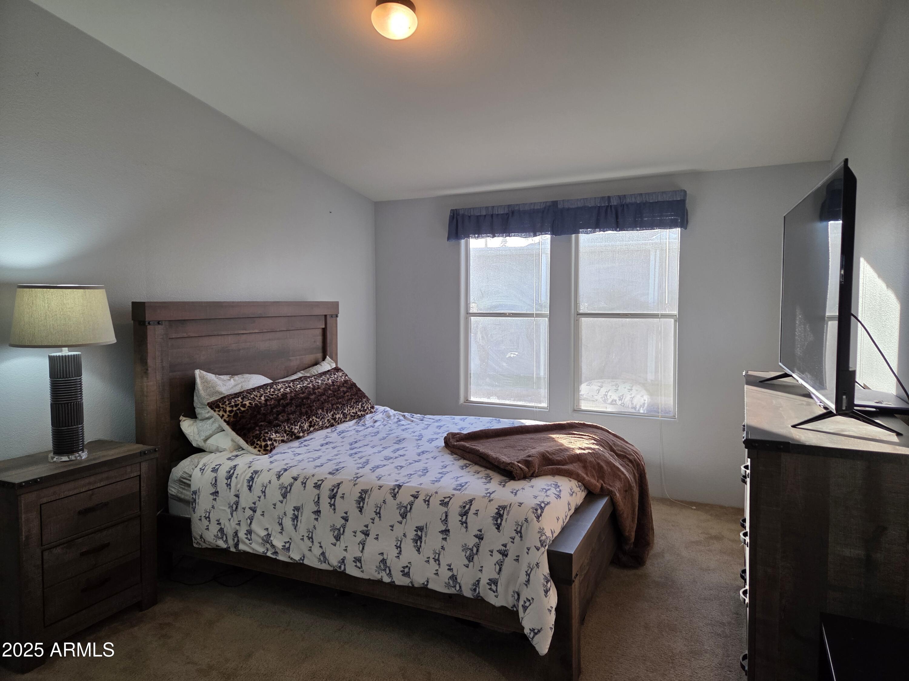2929 East Main Street, Unit 107 Mesa, AZ 85213 - Photo 18 of 42 a bedroom with a bed lamp on table and a window