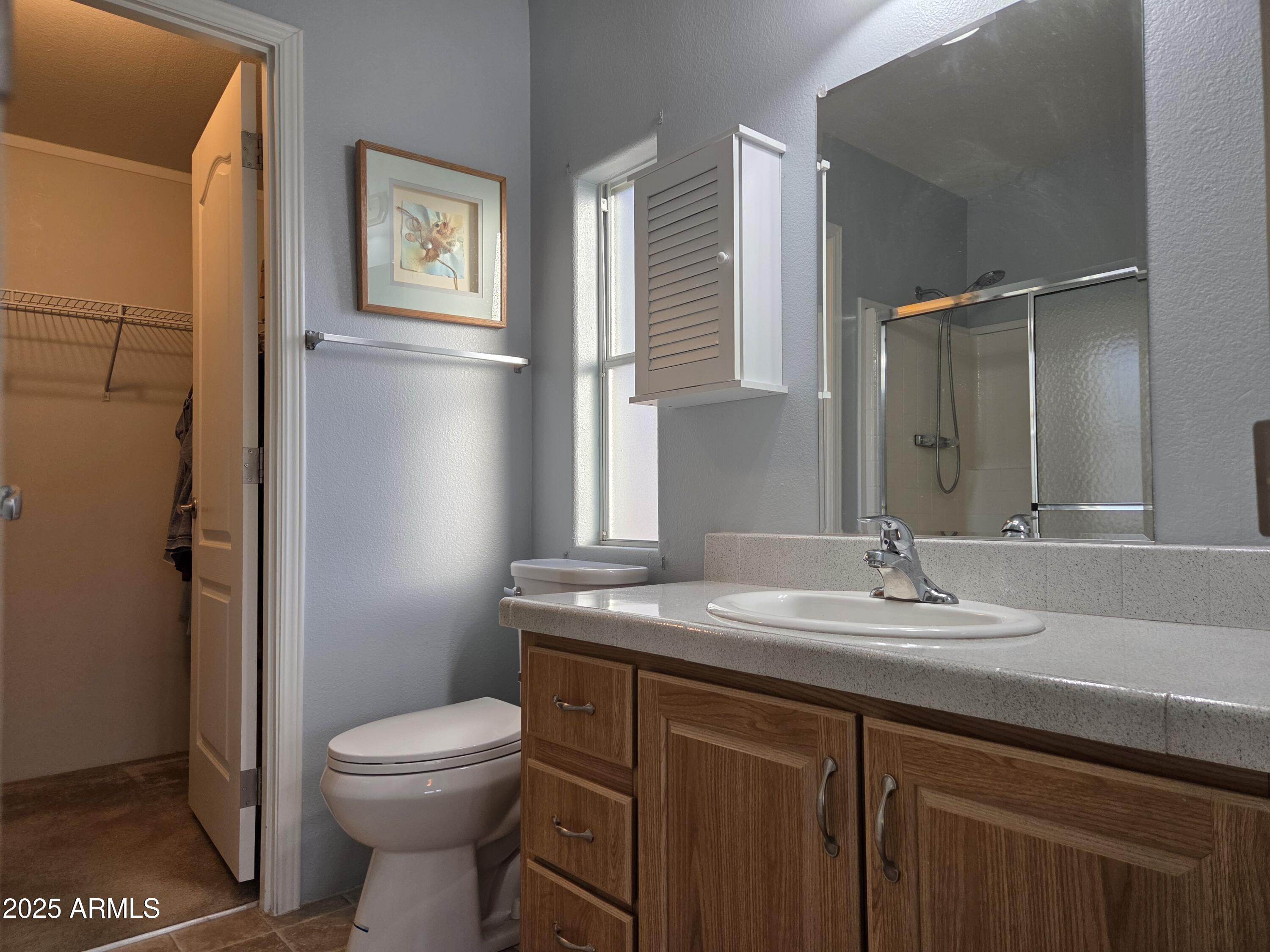 2929 East Main Street, Unit 107 Mesa, AZ 85213 - Photo 20 of 42 a bathroom with a granite countertop sink toilet and mirror