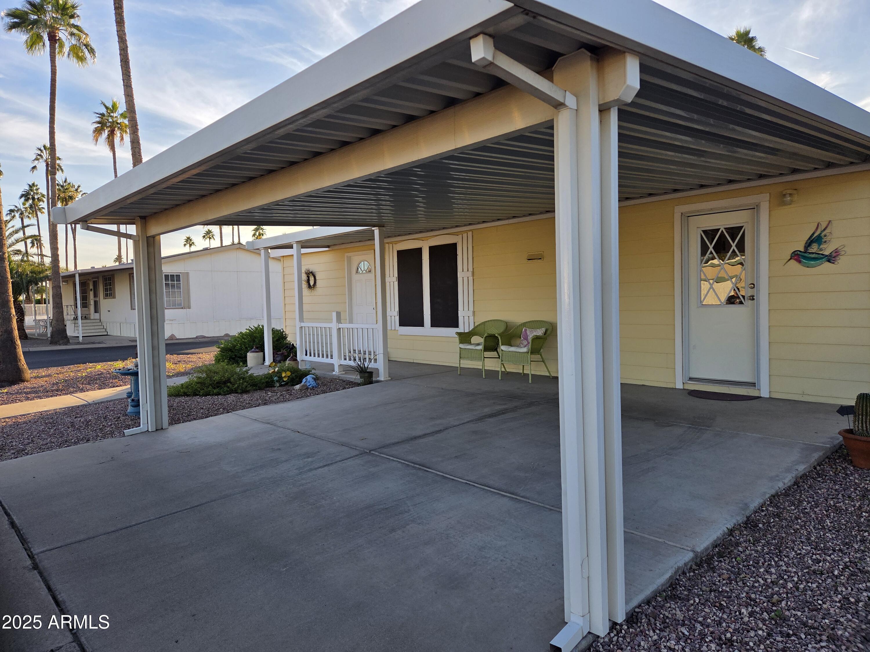 2929 East Main Street, Unit 107 Mesa, AZ 85213 - Photo 2 of 42 a view of a house with porch and seating space