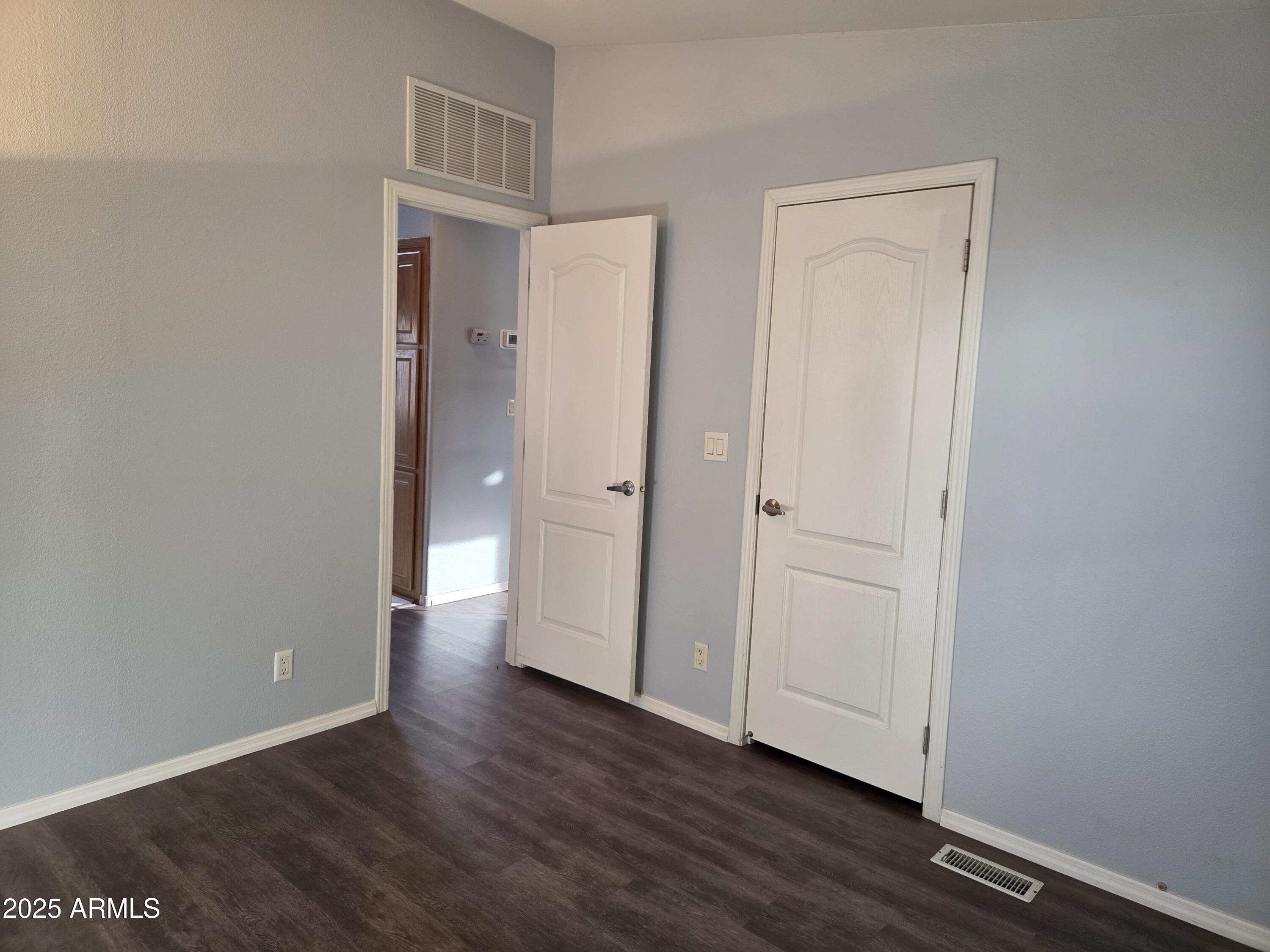 2929 East Main Street, Unit 107 Mesa, AZ 85213 - Photo 25 of 42 an empty room with wooden floor and closet