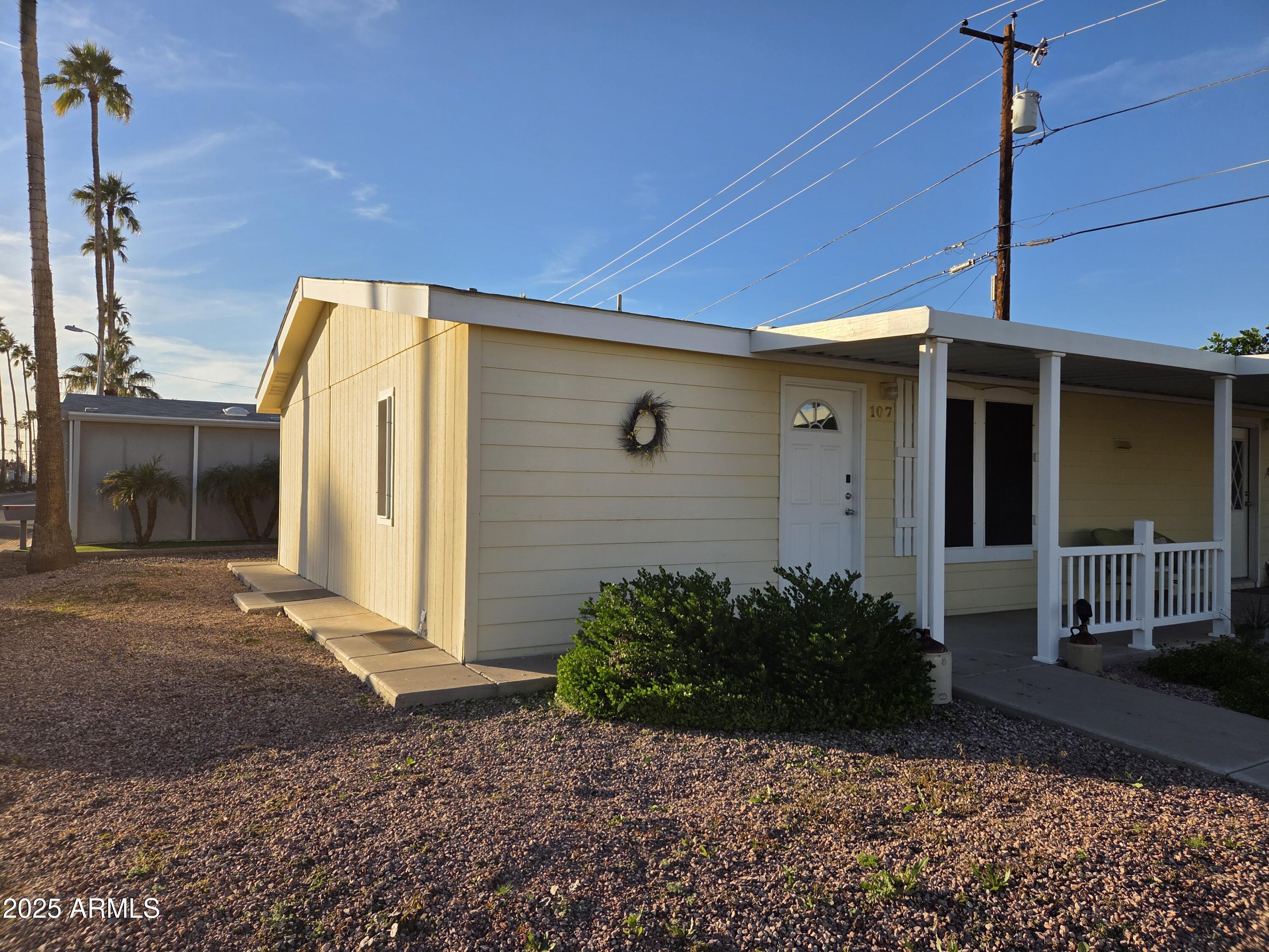 2929 East Main Street, Unit 107 Mesa, AZ 85213 - Photo 3 of 42 a view of a house with a yard