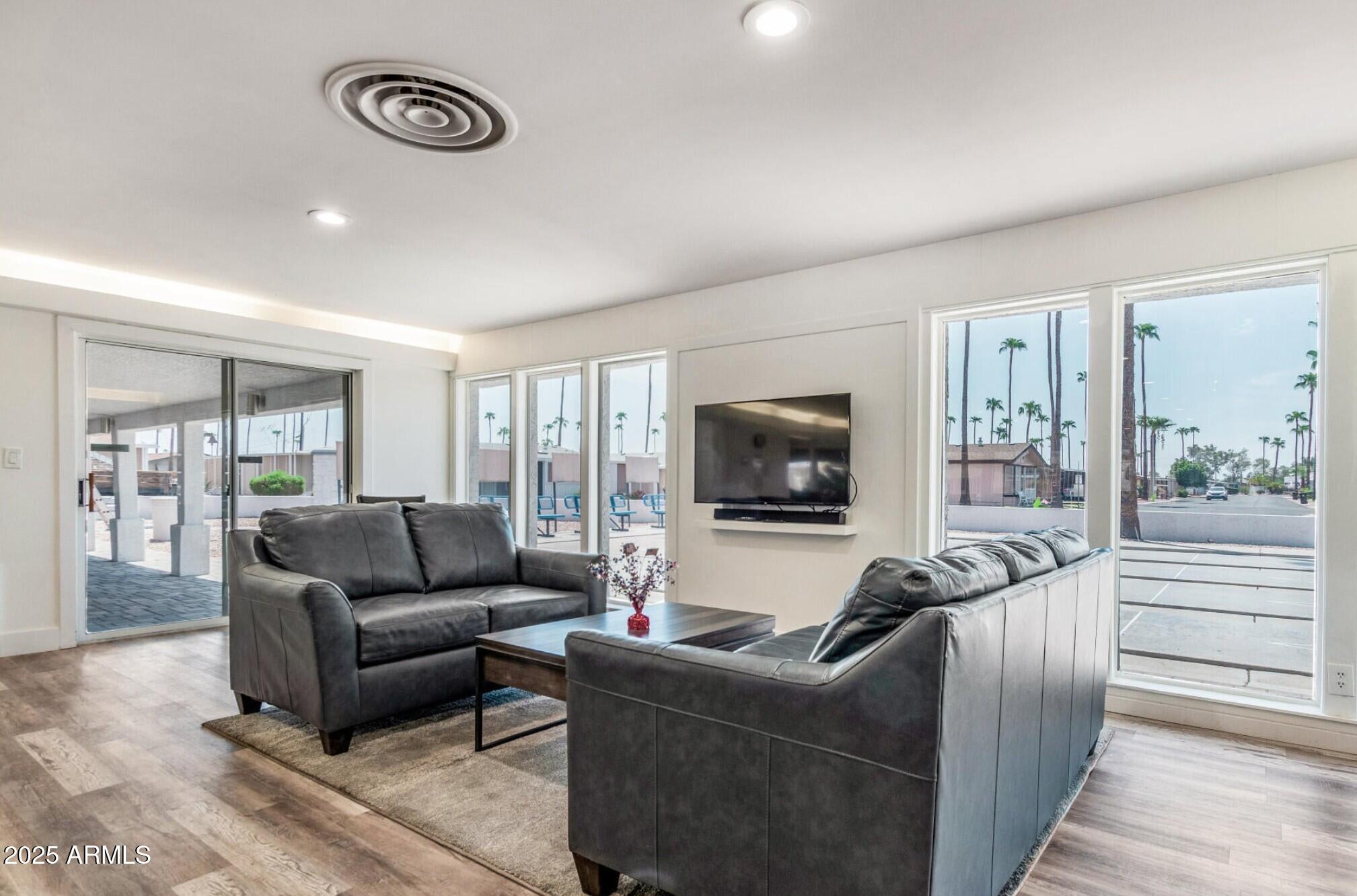 2929 East Main Street, Unit 107 Mesa, AZ 85213 - Photo 34 of 42 a living room with furniture and a flat screen tv