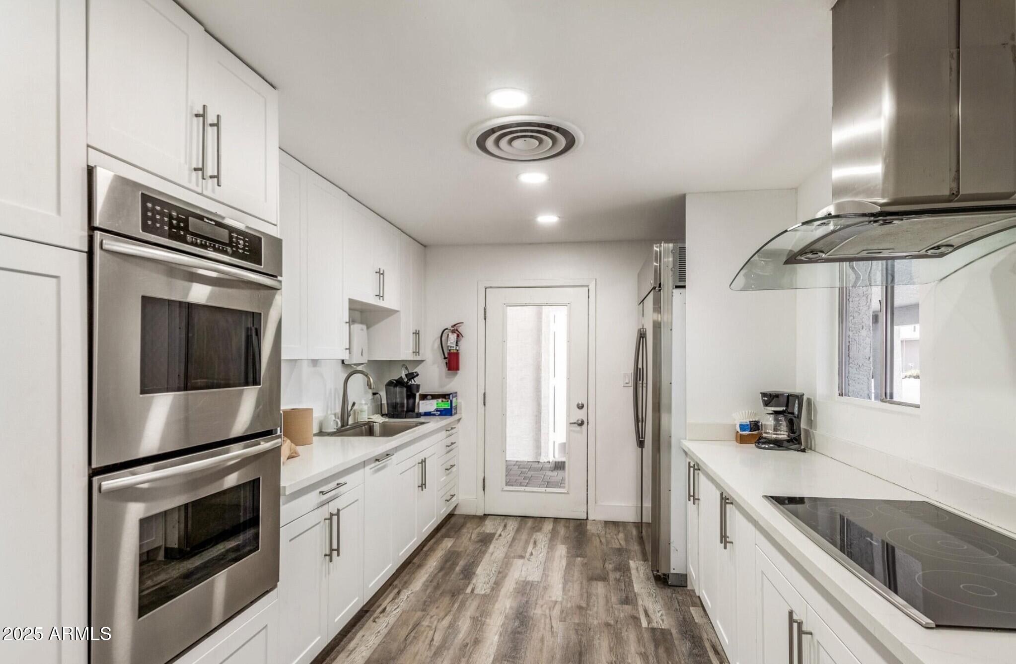 2929 East Main Street, Unit 107 Mesa, AZ 85213 - Photo 35 of 42 a kitchen with stainless steel appliances a stove microwave and a refrigerator