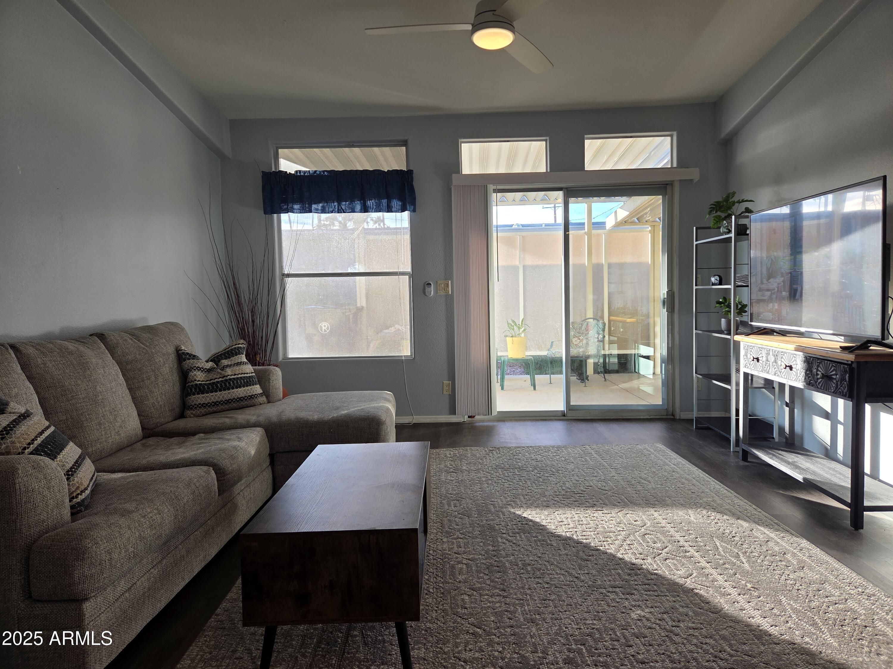 2929 East Main Street, Unit 107 Mesa, AZ 85213 - Photo 5 of 42 a living room with furniture and a flat screen tv