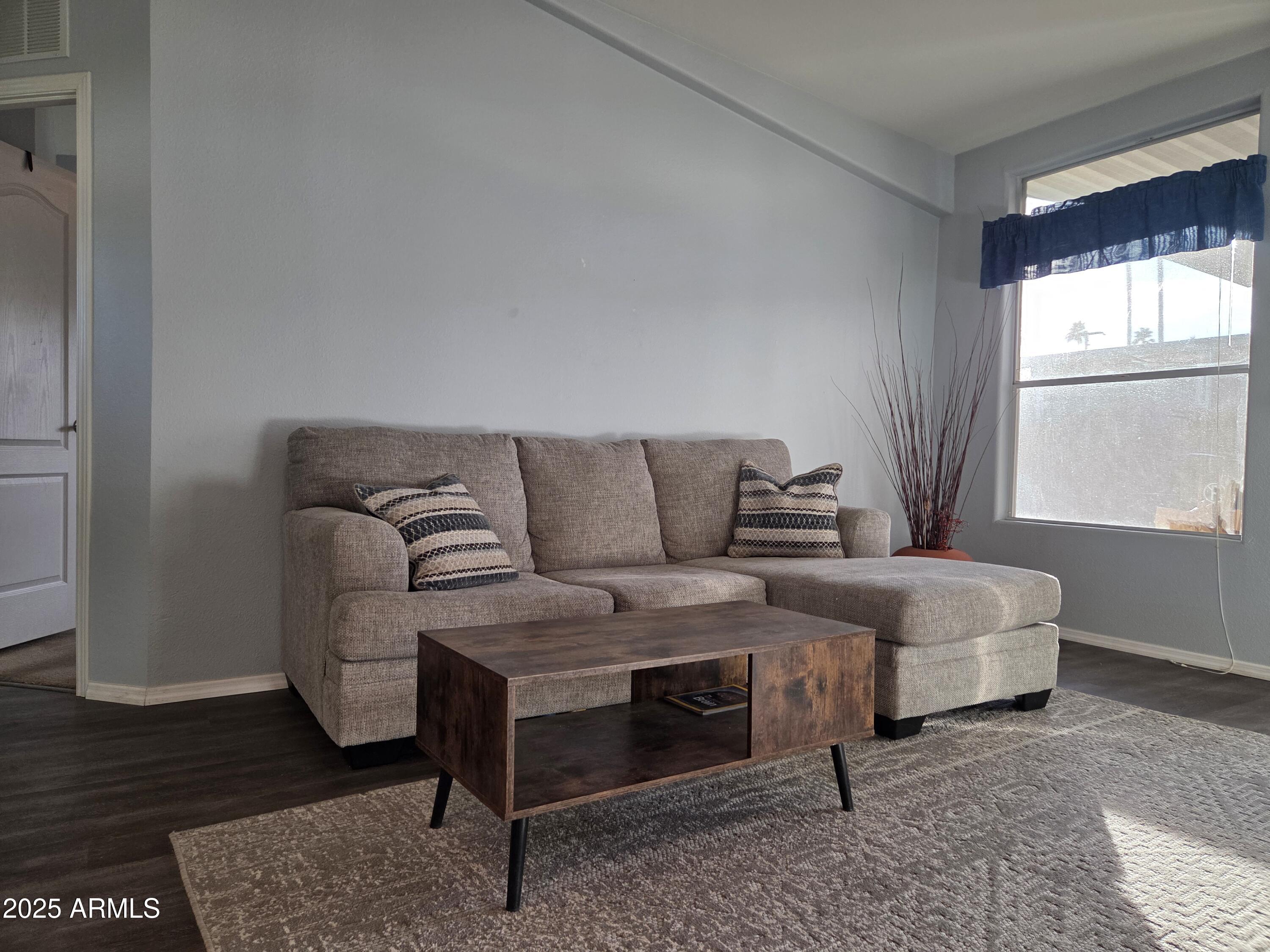 2929 East Main Street, Unit 107 Mesa, AZ 85213 - Photo 6 of 42 a living room with furniture and a window