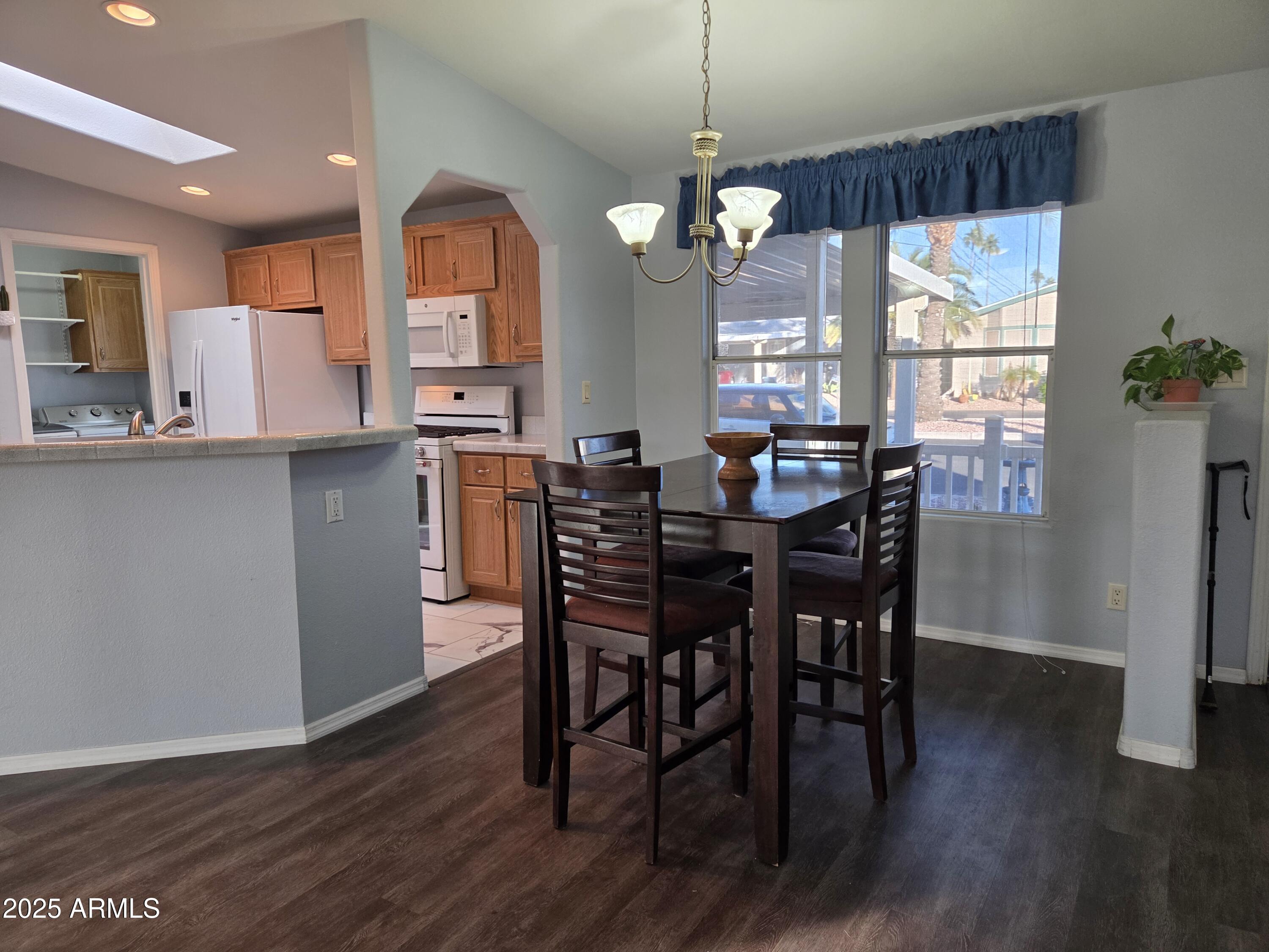 2929 East Main Street, Unit 107 Mesa, AZ 85213 - Photo 9 of 42 a view of a dining room with furniture window and wooden floor
