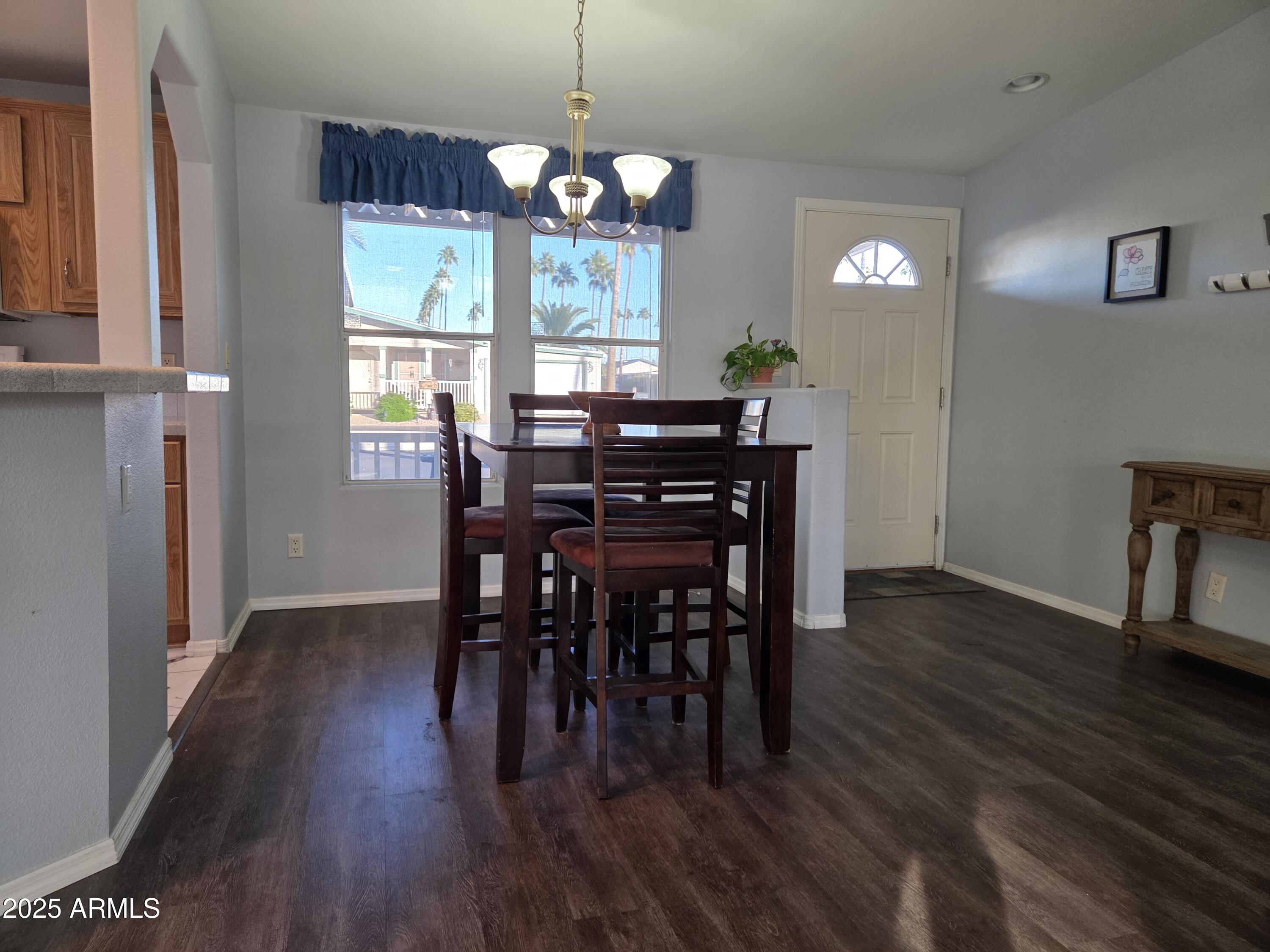 2929 East Main Street, Unit 107 Mesa, AZ 85213 - Photo 10 of 42 a view of a dining room with furniture window and wooden floor