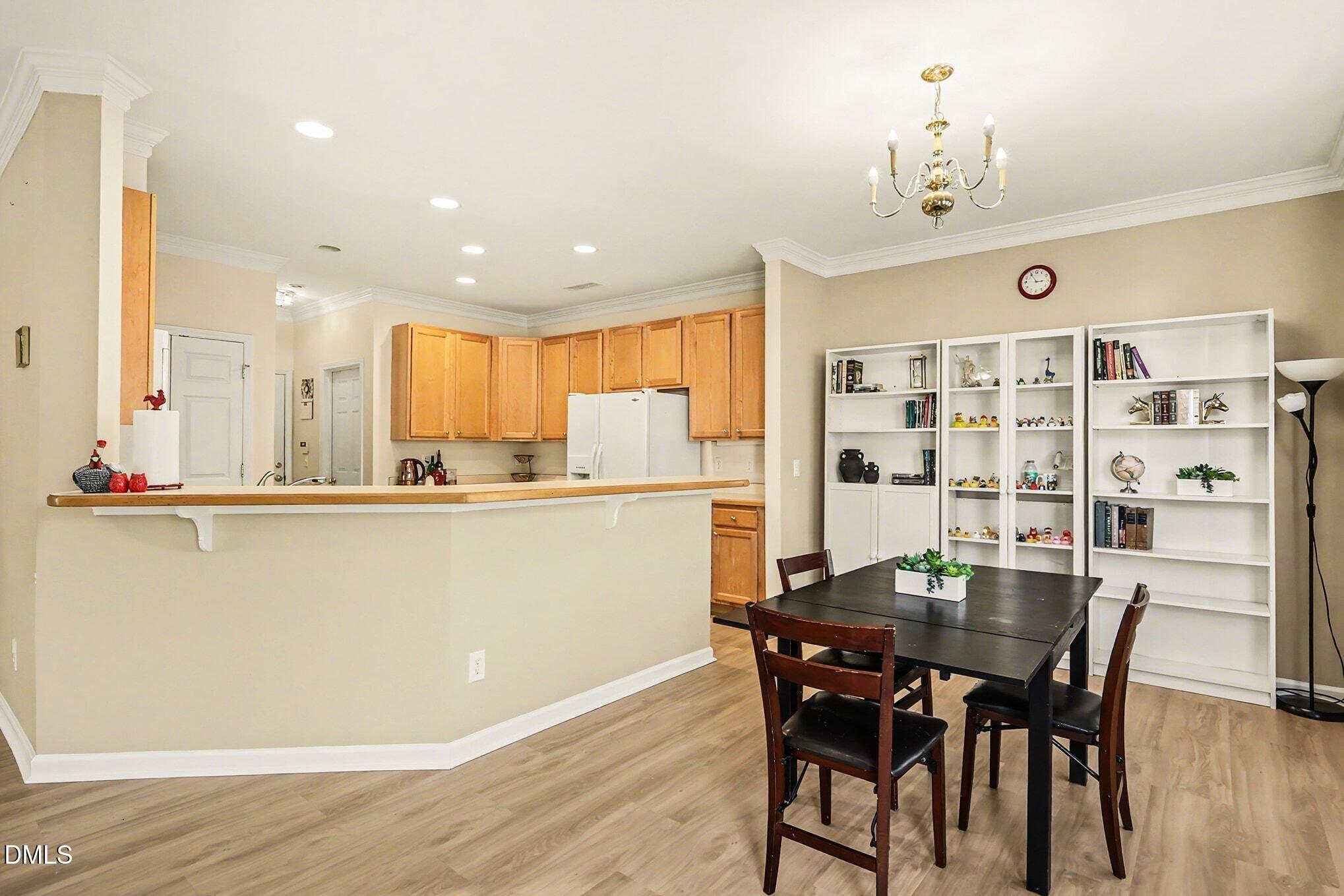 100 Rocca Circle Raleigh, NC 27603 - Photo 10 of 27 a view of a dining room with furniture and wooden floor