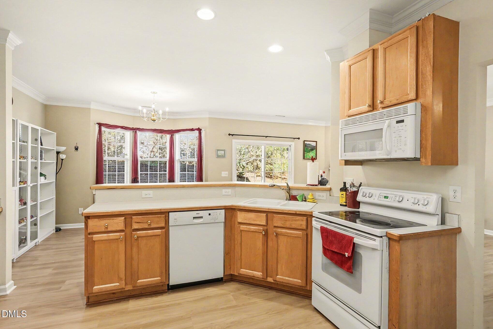 100 Rocca Circle Raleigh, NC 27603 - Photo 11 of 27 a kitchen with a sink stove and cabinets