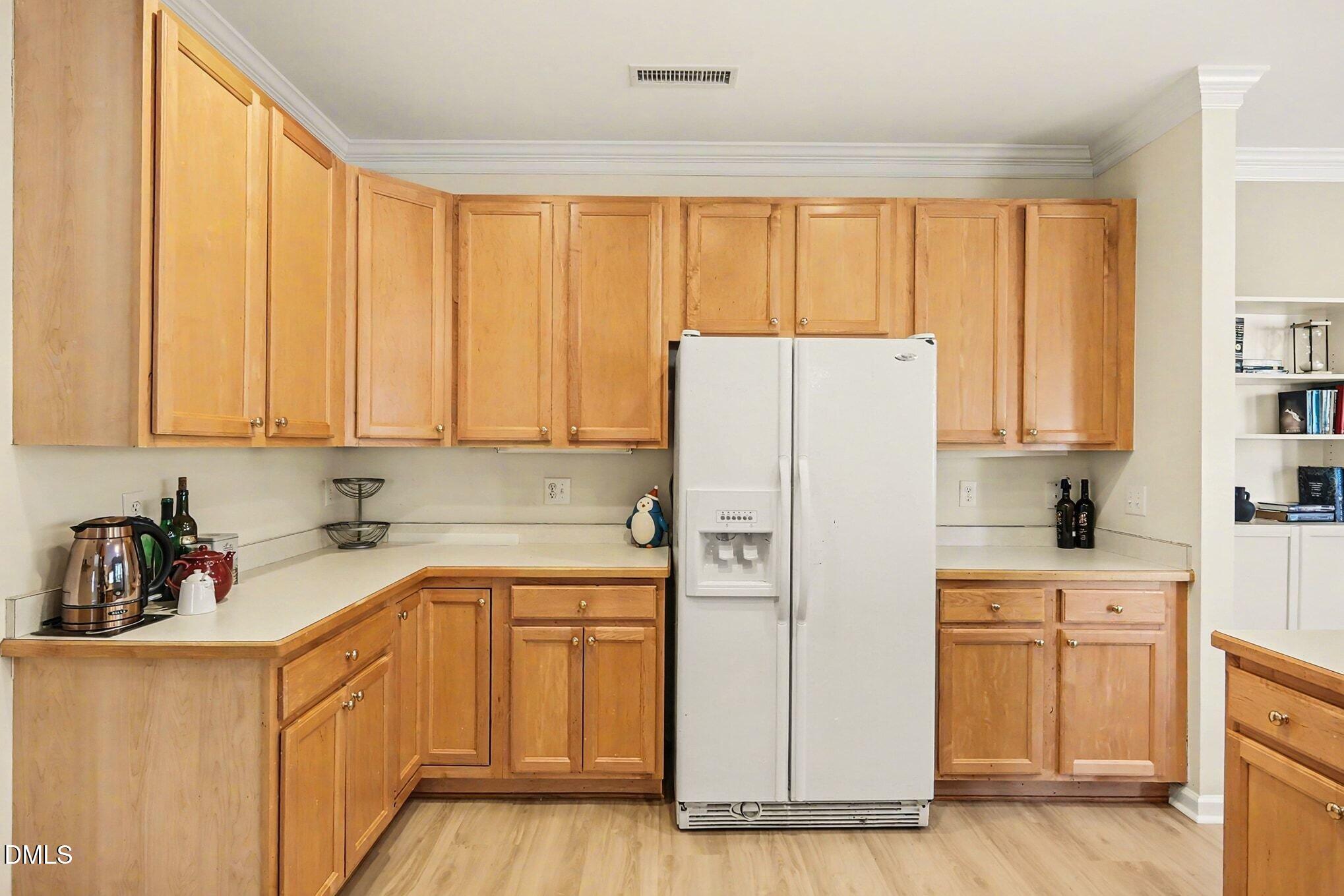 100 Rocca Circle Raleigh, NC 27603 - Photo 12 of 27 a kitchen with a refrigerator a sink and cabinets