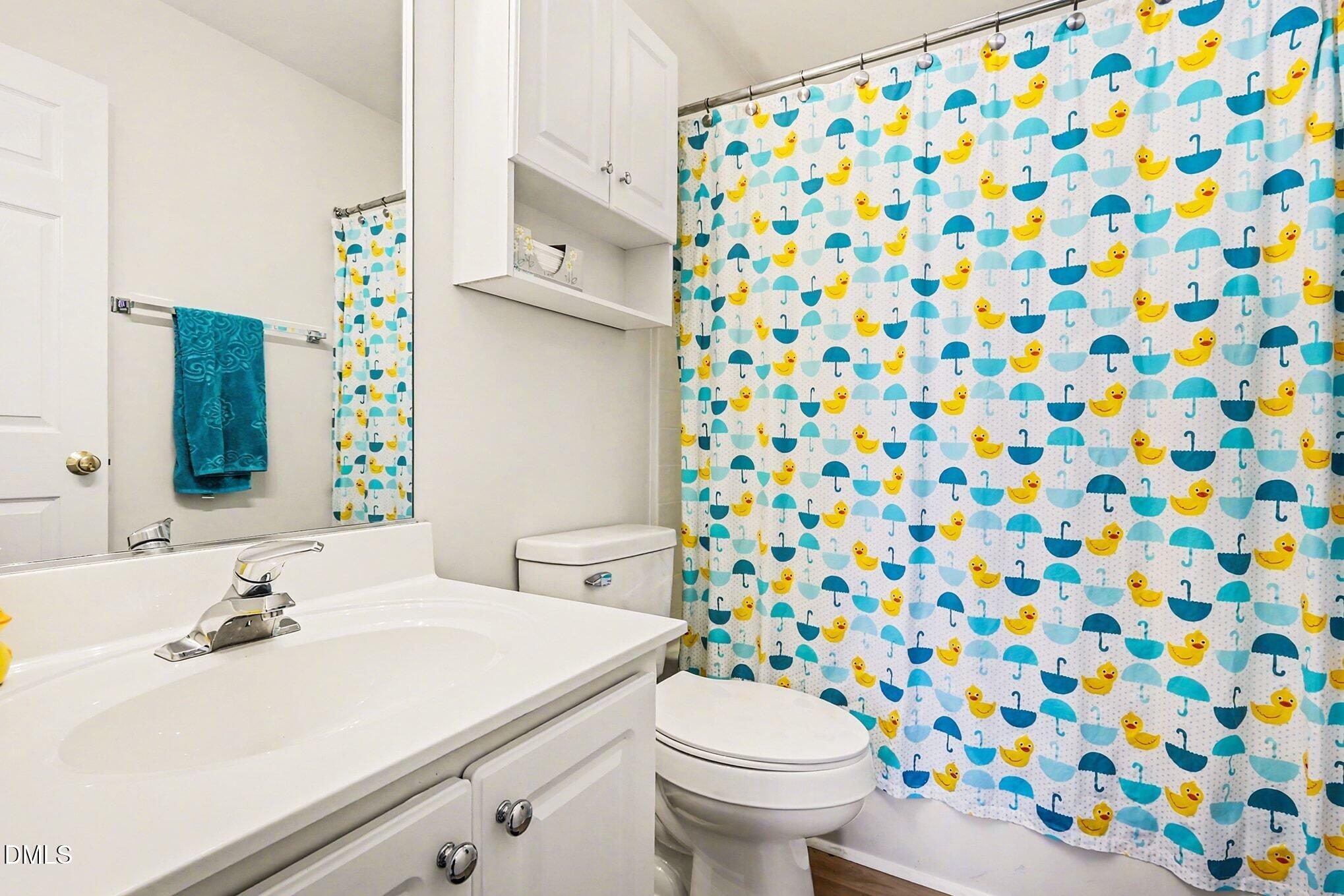 100 Rocca Circle Raleigh, NC 27603 - Photo 20 of 27 a bathroom with a sink toilet and a mirror
