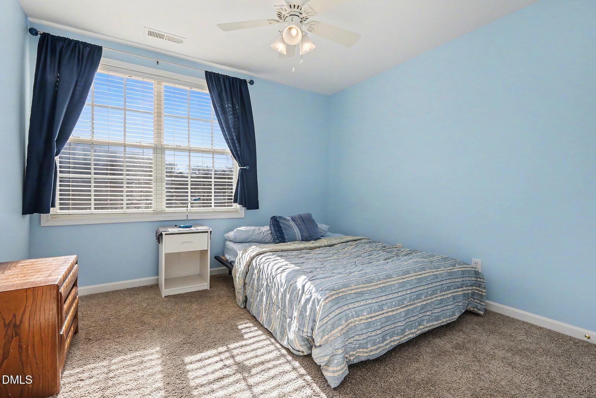 100 Rocca Circle Raleigh, NC 27603 - Photo 21 of 27 a bedroom with a bed and a window