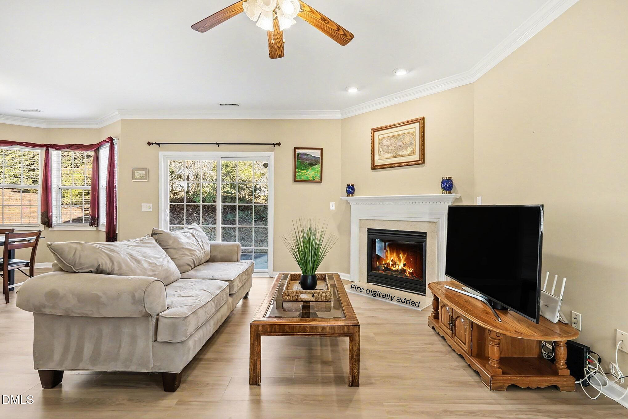 100 Rocca Circle Raleigh, NC 27603 - Photo 6 of 27 a living room with furniture flat screen tv and a fireplace