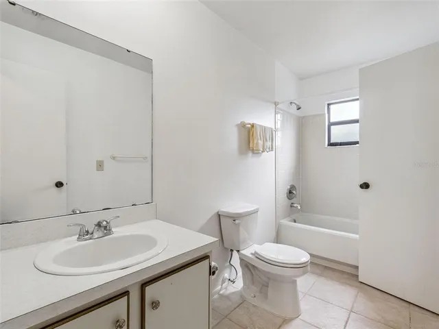 a view of an empty room with wooden floor and fence