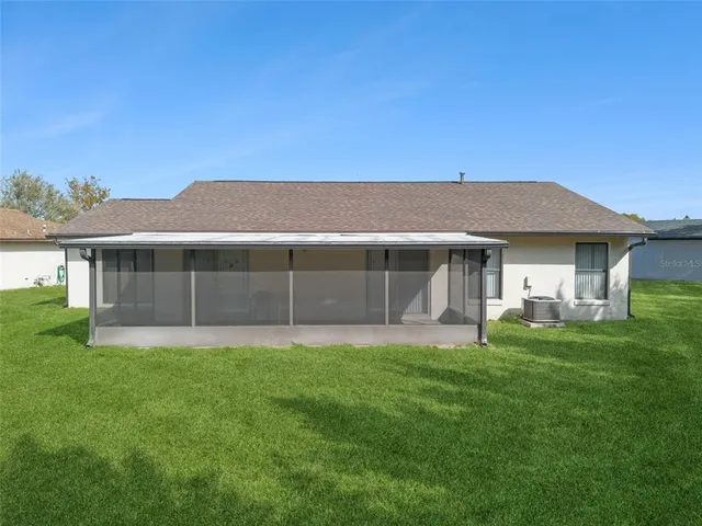 a view of a house with a backyard