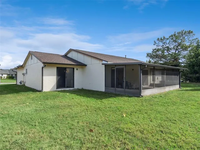 a backyard of a house with table and chairs