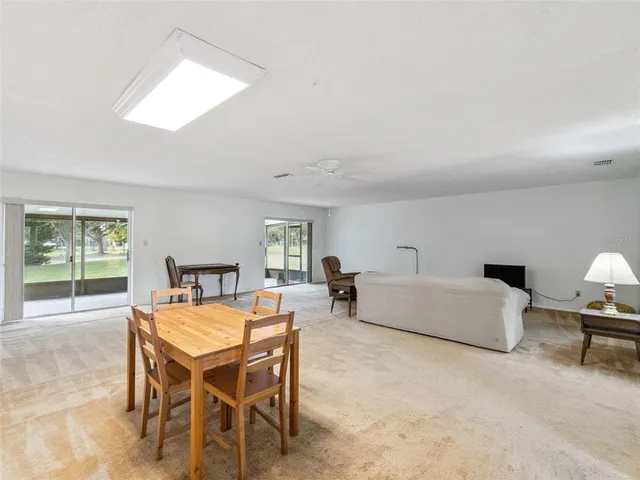 a living room with furniture a table and a window
