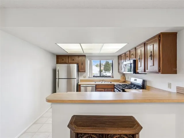 a kitchen with a sink cabinets and window