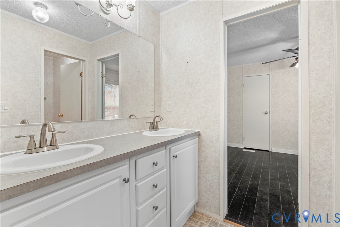 9174 Howardsville Road Howardsville, VA 24562 - Photo 25 of 50 a bathroom with a double vanity sink and mirror