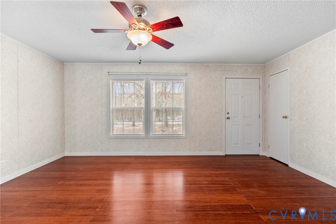 9174 Howardsville Road Howardsville, VA 24562 - Photo 3 of 50 a view of an empty room with wooden floor and a window