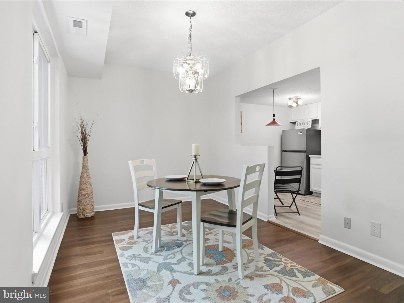 11809 Breton Court, Unit 2B Reston, VA 20191 - Photo 9 of 29 a view of a dining room with furniture and wooden floor