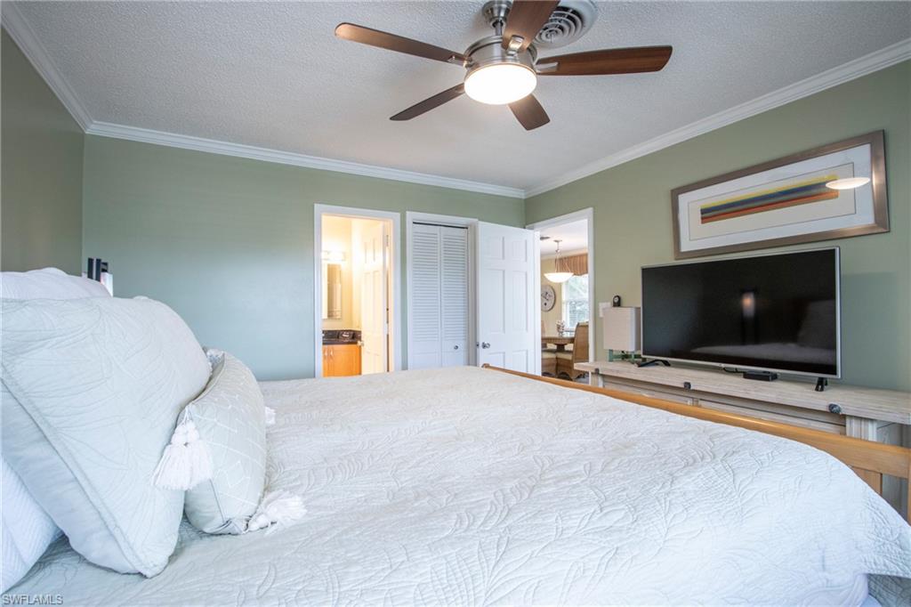 820 Ketch Drive, Unit 8 Naples, FL 34103 - Photo 12 of 16 a bedroom with a bed and a flat screen tv
