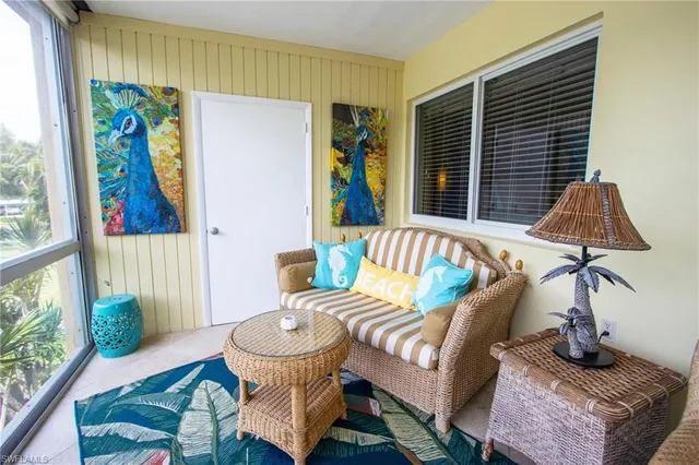 a balcony with furniture and a potted plant