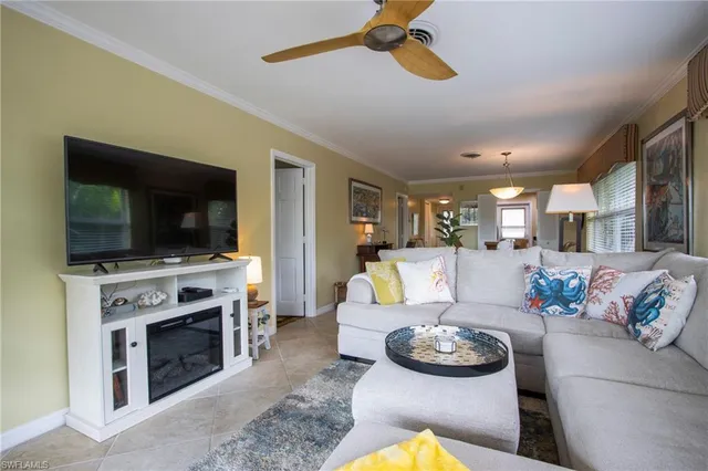 a living room with furniture fireplace and flat screen tv