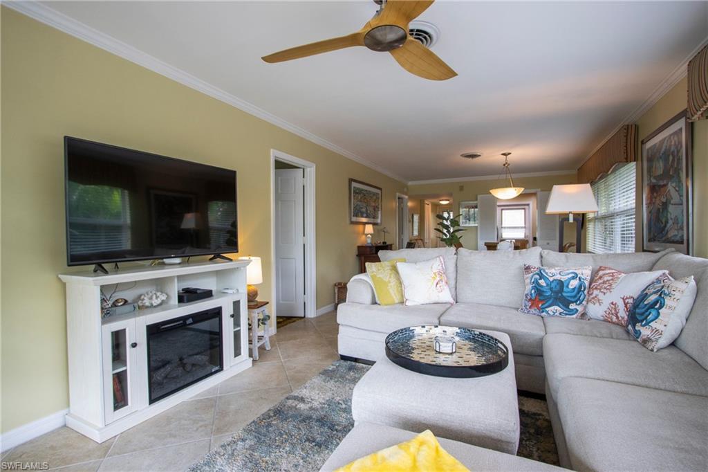 820 Ketch Drive, Unit 8 Naples, FL 34103 - Photo 5 of 16 a living room with furniture fireplace and flat screen tv