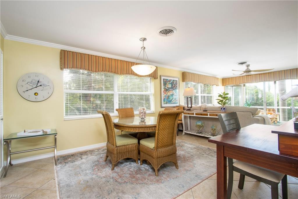 820 Ketch Drive, Unit 8 Naples, FL 34103 - Photo 7 of 16 a dining room with furniture and a large window