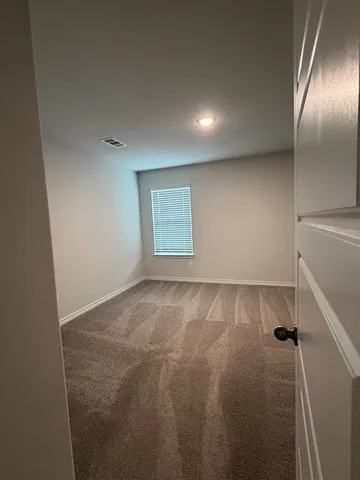 an empty room with a empty space and windows