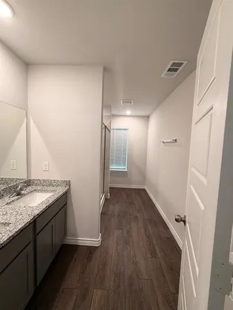 a view of hallway with wooden floor