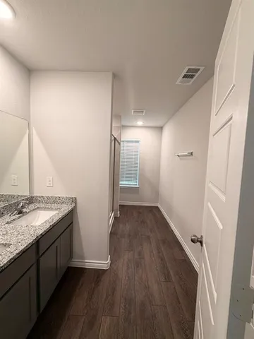a view of hallway with wooden floor